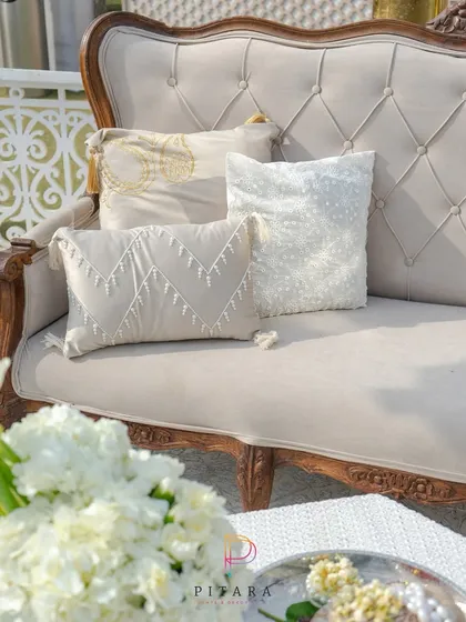 A close-up of the elegant seating, showing the beautifully textured cushions that add another layer of detail to the all-white theme.
