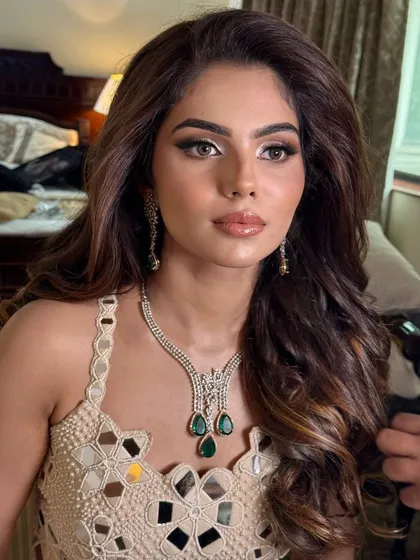 A detailed close-up of this modern glam look. You can see the seamless blend of the eyeshadow and the radiant finish of the skin.