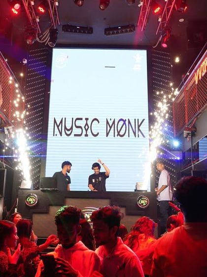 A wide shot of the DJ console at Ginza with my name on the big screen and pyrotechnics going off. I work with venues to create a full production, not just a DJ set.
