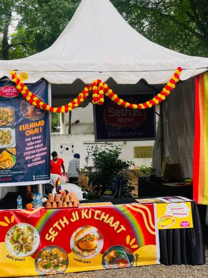Our food stall is ready for business at the Maya Bazaar. We love being part of community markets, complete with our colorful banners and a rainbow flag flying high.
