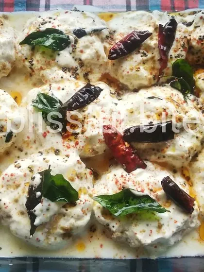 A tray of refreshing Dahi Vada, a popular South Asian snack perfect for cooling down.