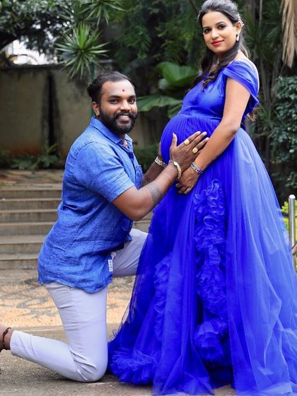A beautiful couple's maternity photo. The vibrant royal blue of this ruffled gown makes a bold statement, celebrating the new life they are waiting for together.