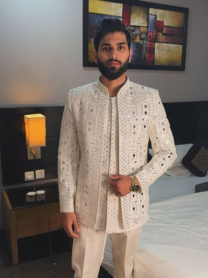 A front view of the off-white mirror work jacket. The detailed craftsmanship is visible across the entire garment, creating a shimmering and eye-catching effect.