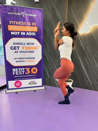 A member demonstrates excellent form in the Eagle Pose, showcasing her flexibility and strength.