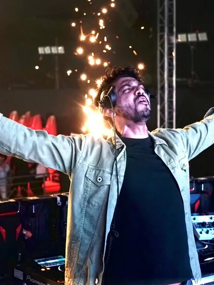 My two rules: Party like there's no tomorrow, and always follow rule number one. This shot captures it all: arms open, mic in hand, and pyrotechnics lighting up the stage.