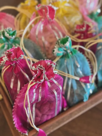 A tray of vibrant potlis, ready to be assembled into bespoke festive hampers.
