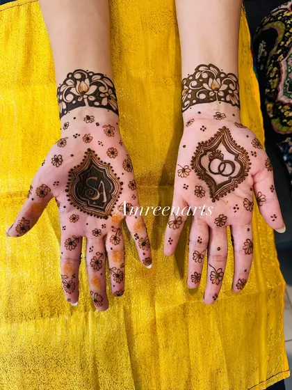 A minimalist take on personalization, with the couple's initials on one hand and intertwined rings on the other, surrounded by delicate floral dots.
