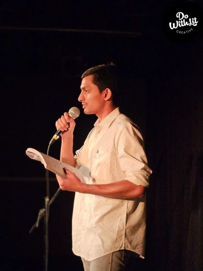 A storyteller reading from his book, bringing his narrative to life for our audience.