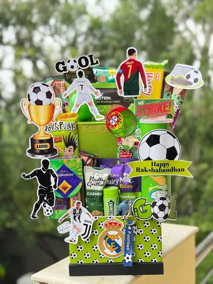 For the football fanatic brother. This hamper is themed around his favorite sport, featuring football-themed decorations, snacks, and even a keychain. A sure-shot goal of a gift.