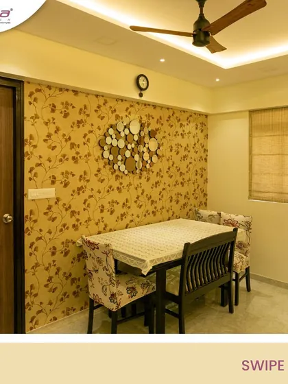 A dining area with a beautiful floral wallpaper and a modern wall-mounted clock. The design is simple, elegant, and creates a pleasant atmosphere for family meals.