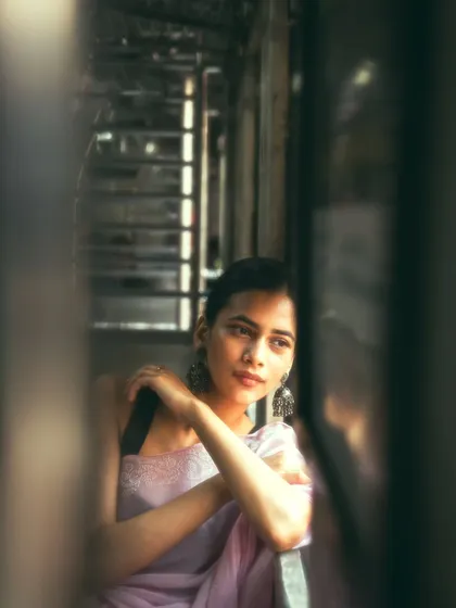The Mumbai local train is a character in itself. I used its unique environment to frame this candid, thoughtful portrait, finding a moment of calm in the middle of the city's hustle.
