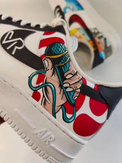 A detail shot showing a hand holding a microphone, a nod to the client's successful career as an emcee. It's these personal touches that make a pair truly unique.
