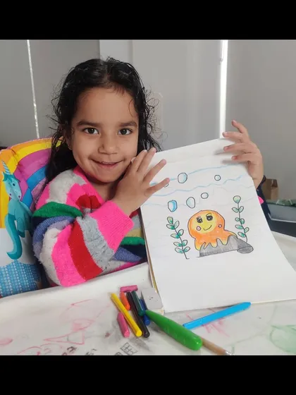 This young artist is all smiles with her underwater octopus drawing. My classes help children explore the mysteries of the ocean and its creatures through fun art projects.