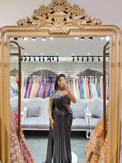 A full-length mirror selfie showing off this stunning grey pre-draped saree. The embellished blouse and sleek drape make it perfect for a cocktail party.