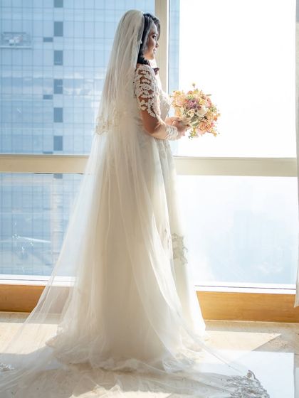 A full-length shot showing Irene's beautiful gown and long, flowing veil. Her hair and makeup complete the angelic picture.
