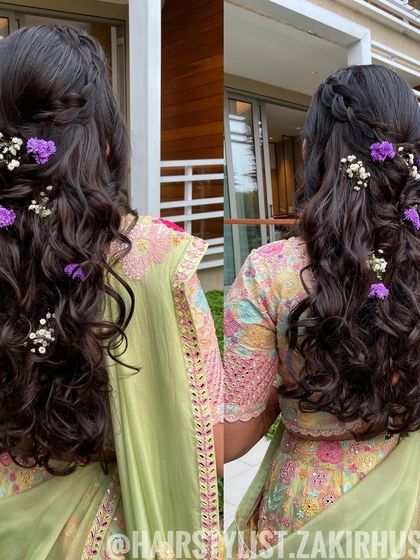 A dual-angle view of the half-up style with purple flowers, showing the romantic and fresh look.