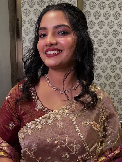 A close-up of the bride's happy face, her makeup looking fresh and vibrant.