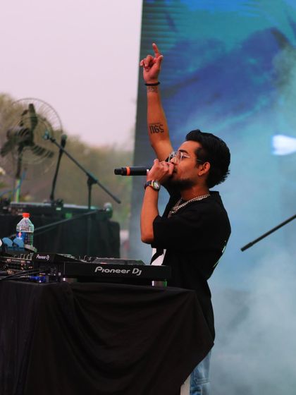 Pointing to the sky at the Music and Masala Fest. This is me in my element, leading the crowd and mixing tracks on my Pioneer DJ setup.