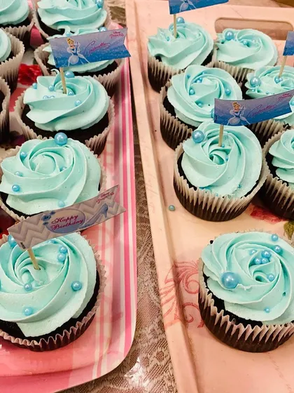 I love creating cupcakes that match a party's theme. These are from a Cinderella themed birthday, featuring light blue buttercream, sparkly sprinkles, and custom toppers. We can tailor the colors and decorations for any theme your child loves.