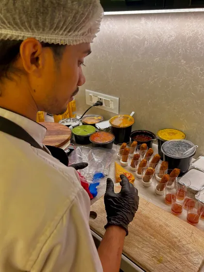 An inside look at the prep station for a gourmet event. My chef is meticulously arranging fish fingers and preparing various dips and sauces.