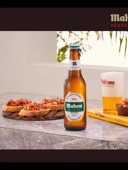 Staging a Mahou beer in a bright, modern lifestyle setting with fresh bruschetta. The goal is to help customers visualize enjoying the product in their own lives, making the brand feel accessible and familiar.