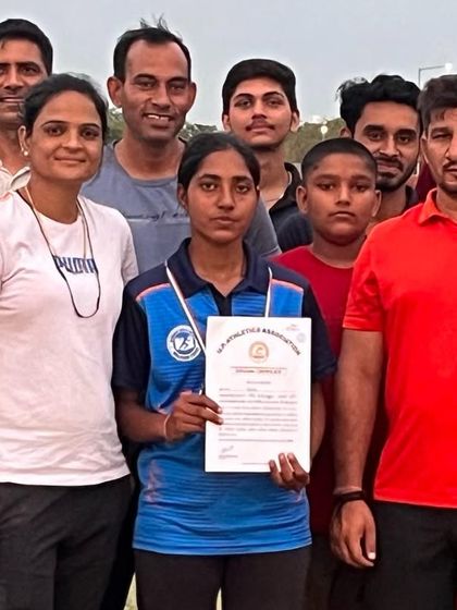 The team celebrates Komal's gold medal win in the 3000m steeplechase. An individual victory is a victory for the entire academy.