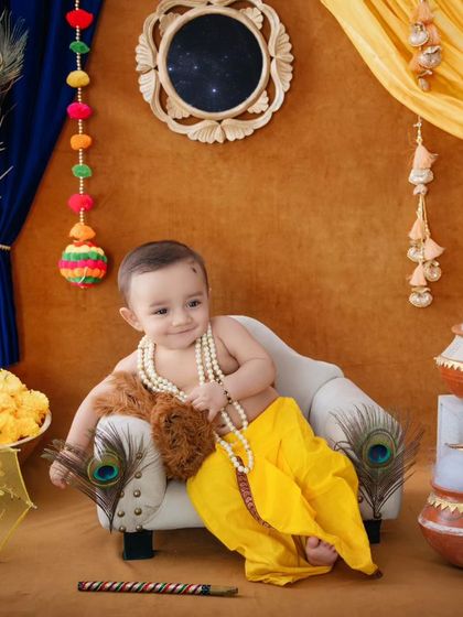 This little Krishna is ready for mischief, with his hand in the butter pot and a sweet smile on his face.