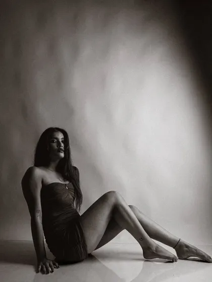A beautiful, artistic pose in black and white. The light and shadow play across her body, creating a very elegant and timeless image.