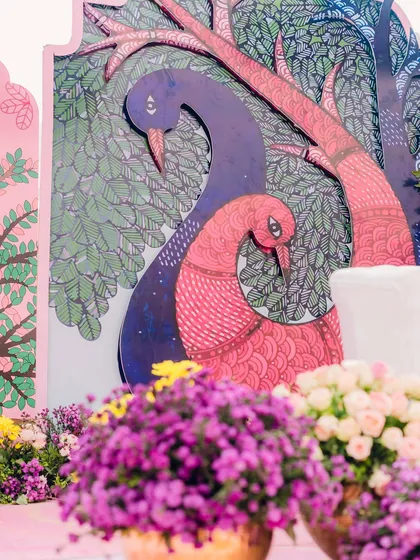 A close-up of the custom illustrated panels from a carnival decor setup. The detailed artwork of two peacocks adds a unique and artistic touch that elevates the entire design.
