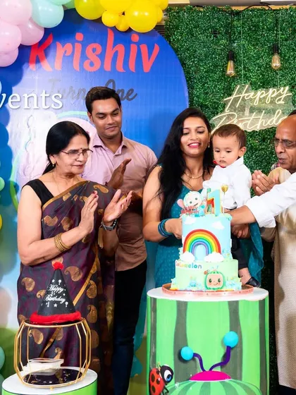 Capturing the cake cutting moment at a fun Cocomelon party.