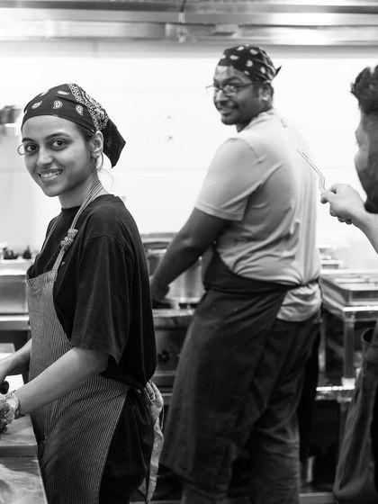 A sneak peek behind the scenes. My team works together in the kitchen, smiling and enjoying the process of creating delicious food.