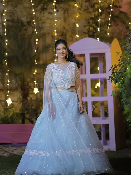 A full-length view of the fairytale sangeet gown. The makeup is kept soft and ethereal, with a curly ponytail to add a touch of whimsy.