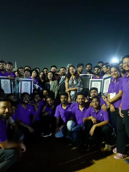 A candid shot of our team and supporters posing with the Guinness World Record certificates, showcasing the collaborative spirit behind this monumental achievement.