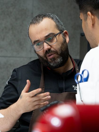 A moment of mentorship as Chef Karim Bourgi discusses techniques with one of our chefs.