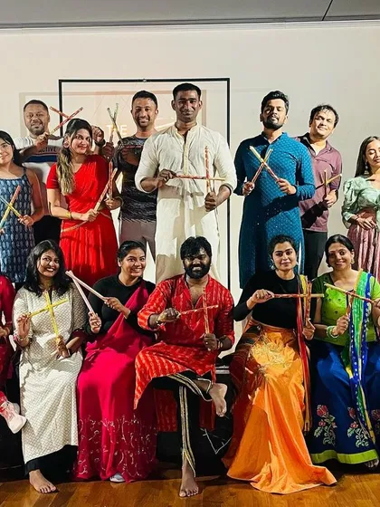 Posing with our Dandiya sticks! We teach basic Garba and Dandiya steps so everyone, including beginners, can join in the fun.
