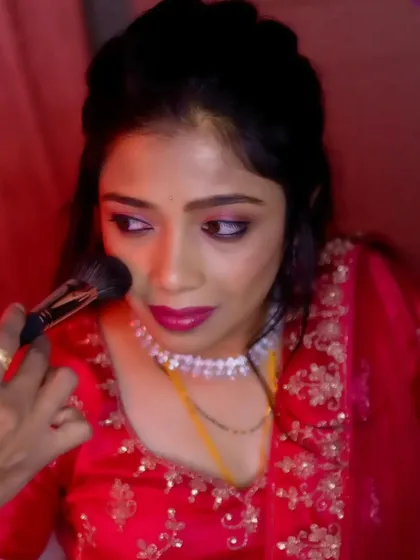A candid shot of me applying blush during Vasudha's reception makeup session.