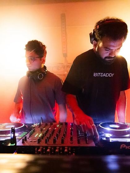 Another dynamic duo on the decks, with one DJ wearing a "Bitdaddy" shirt, adding a touch of personality to the underground music scene we foster.