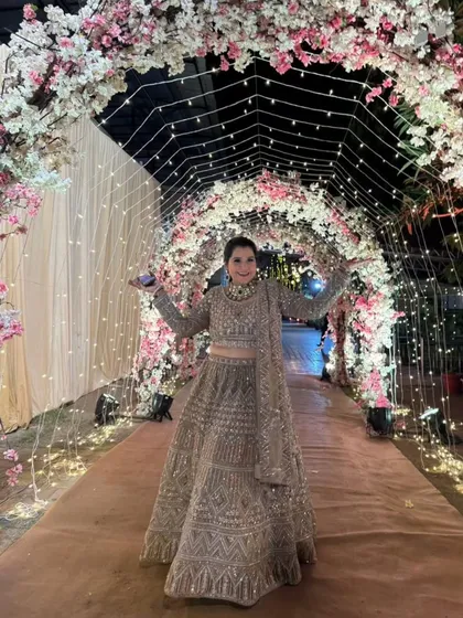 Our client looks like she's walking on a cloud in this gorgeous embellished beige lehenga. The perfect outfit for a magical evening.