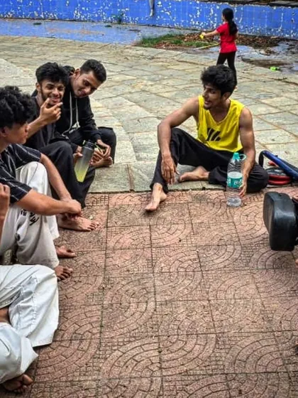 A candid moment of rest and conversation between students after a tough training session.
