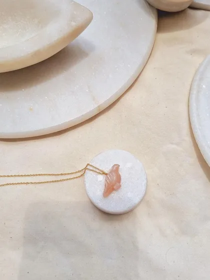 A simple, elegant shot of the peach moonstone 'dóve' pendant.