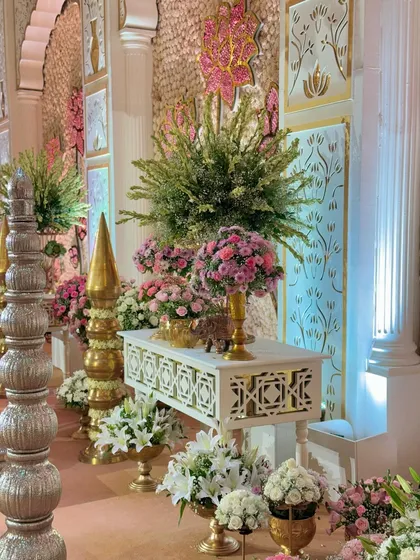 A side view of a decor corner, showcasing the tall, traditional pillars and the lush floral arrangements that bring the space to life.