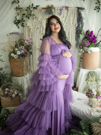 A joyful and radiant solo portrait. The mother-to-be's happy smile and the beautiful tiered lavender gown make this a truly heartwarming shot.