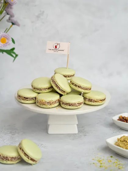 We've combined French technique with Middle Eastern flavor in our Kunafa Macarons. Delicate pistachio macaron shells are filled with a creamy center and wrapped in crunchy kunafa for a truly unique gourmet treat.