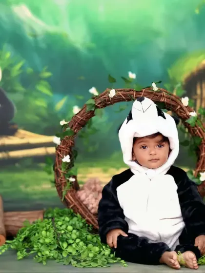 This little one is all dressed up in a panda costume, sitting sweetly in our bamboo forest set for a cute and cuddly portrait.