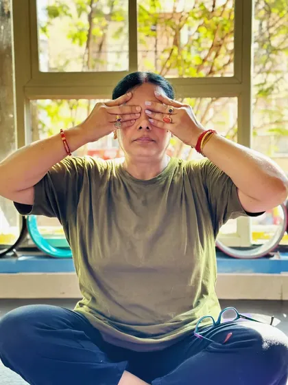 A student practices Bhramari (Bee Breath), a calming pranayama that soothes the mind and relieves tension.