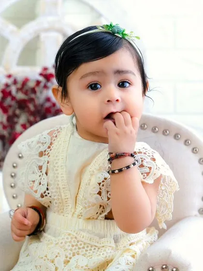 Sweetness overload with this little angel. Her curious expression and delicate lace outfit make for a beautiful and timeless portrait.