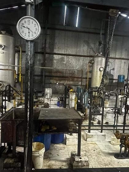 Inside the oil refinery, this photo shows the complex machinery and industrial environment where we provide our financial and compliance services.