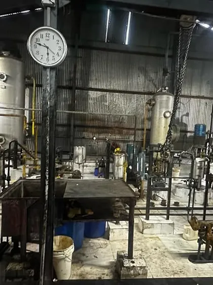 Inside the oil refinery, this photo shows the complex machinery and industrial environment where we provide our financial and compliance services.