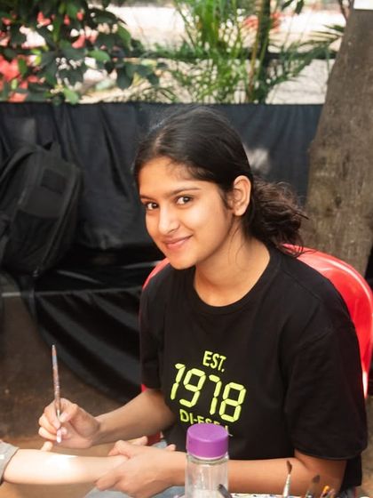 A behind-the-scenes look at the party fun. Capturing the artists and activities, like this hand-painting station, adds depth to the event's photo gallery.