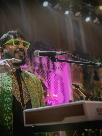 Our keyboardist, in a striking green jacket, enjoying the vibrant atmosphere of the show.